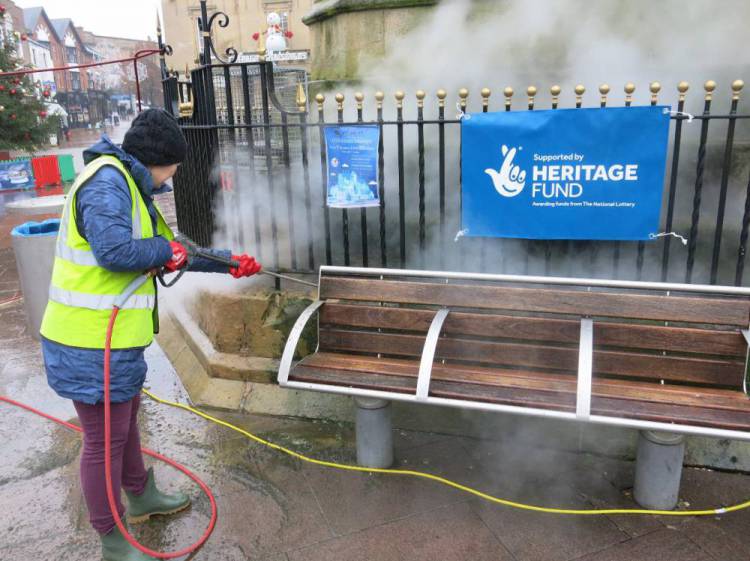 A Townscape Heritage Project volunteer is instructed in the use of ThermaTech stone masonry cleaning equipment, by personnel from the specialist conservation company Recclesia.