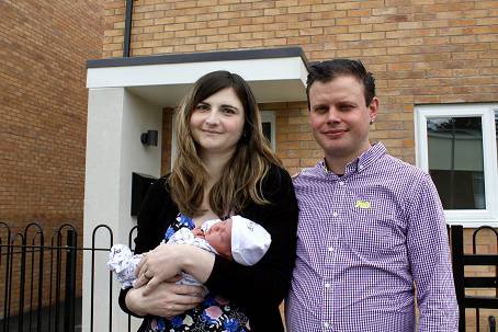 Photo of Carrie and Daymun Green and their son Leo outside their new home in Saundby Avenue