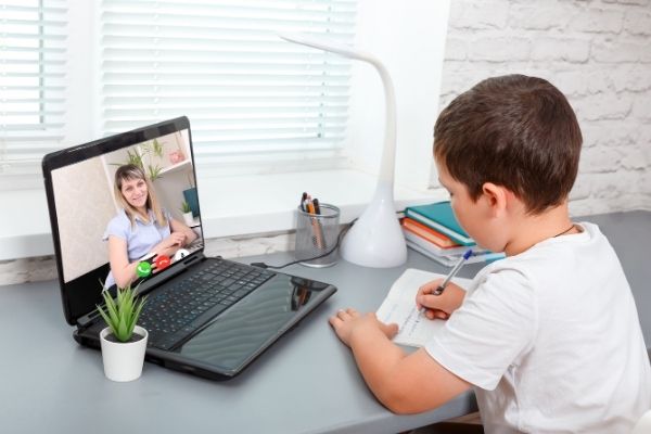 A picture of a young boy on a laptop
