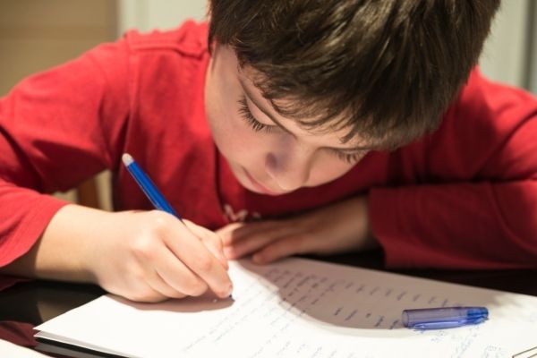 A picture of a young boy writing