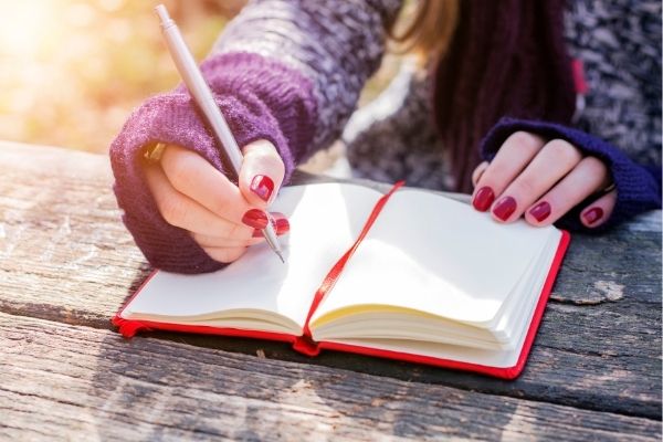 A picture of hands writing in a book