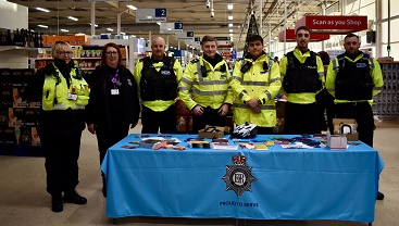 Police and council officers handing out bicycle locks in Tesco.