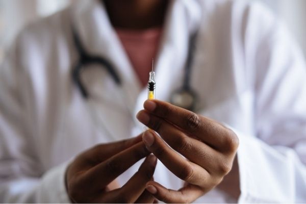 A photo of a doctor holding a flu vaccination