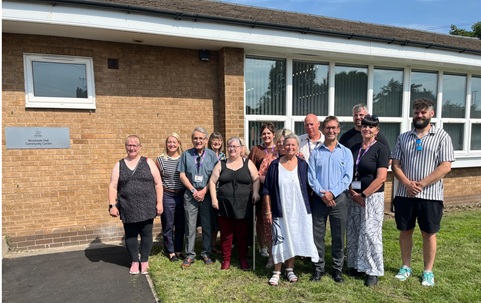 Photo of people outside Brookside Hall at the reopening event including the Mayor, councillors and council officers.