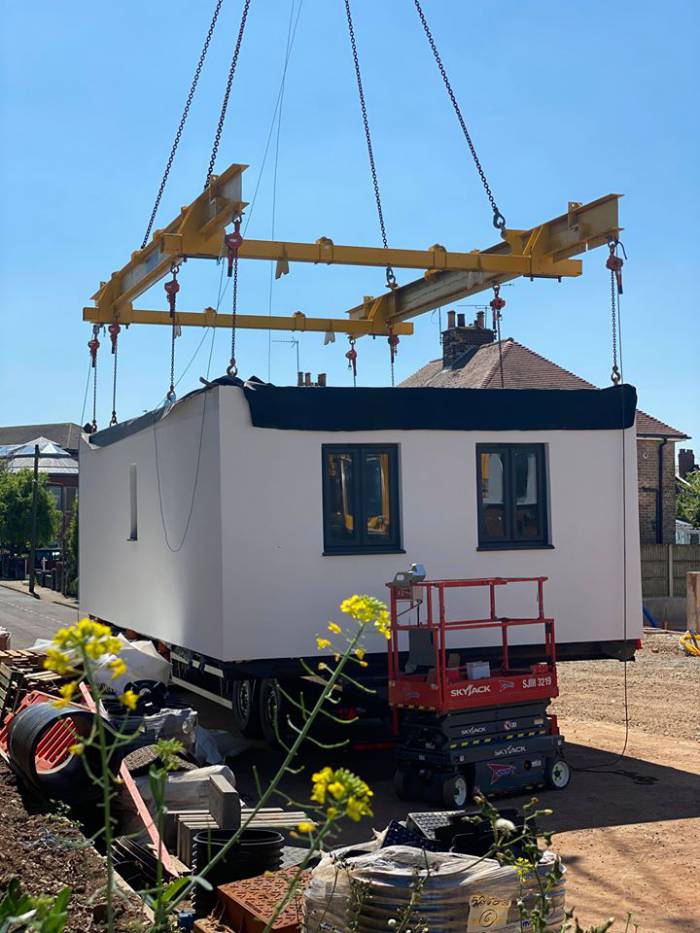 Photo of a modular house being lowered into place in Rosemary Avenue