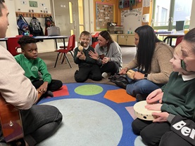photo of Musician in Residence Erika Zeckser Owen with pupils at Oak Tree Primary School