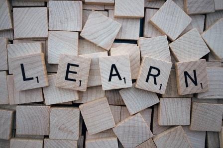 The word learn spelt out with wooden scrabble tiles