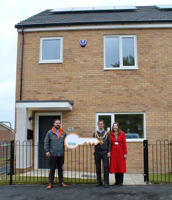 Photo of Tom Woodhead, Business Services Director for Robert Woodhead Ltd, officially hands the properties back to Executive Mayor Andy Abrahams and Cllr Marion Bradshaw on behalf of Mansfield District Council