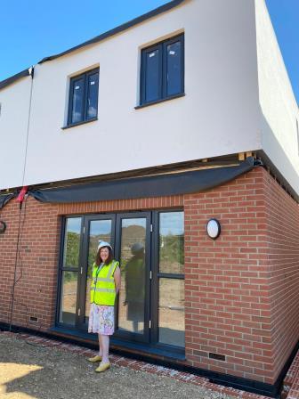 A photo of Cllr Bradshaw with modular housing at the Rosemary Street Housing Development