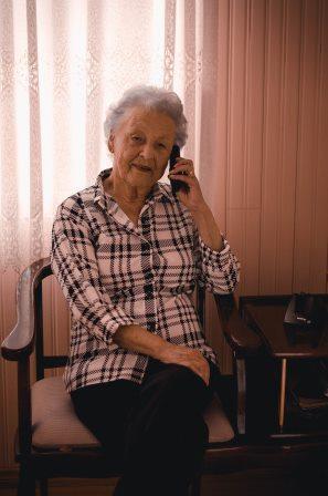 A photo of an older person on the phone
