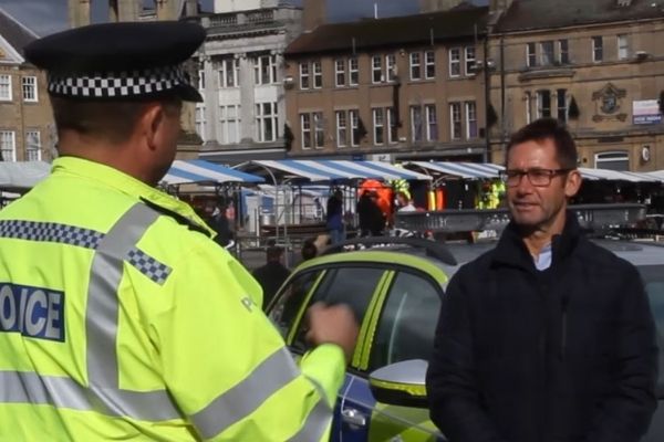 A photo of the Mayor talking to a Police Officer