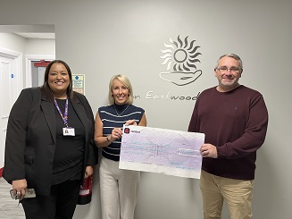 Photo of giant cheque being presented by Cllr Burgin to hospice