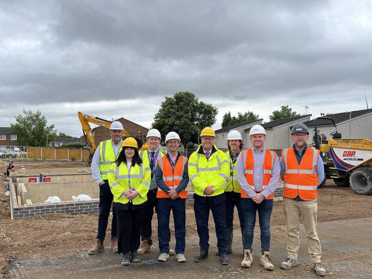 The project team, Mayor and Chief Executive stood near to the construction of new council homes