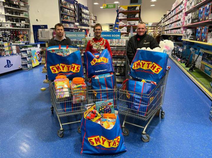 Men stood with trolleys filled with Smyths toys