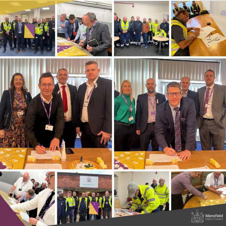 A photo showing various council officers signing the White Ribbon pledge