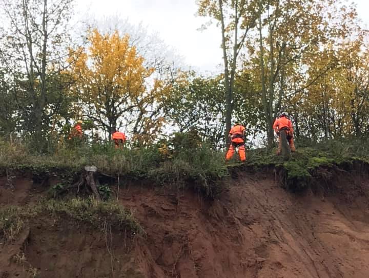 Workers at the site of the Berry Hill Quarry mudslide.