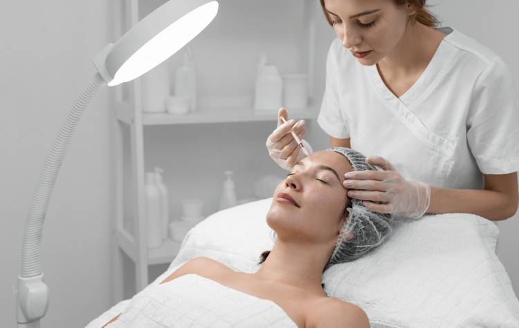 A beautician performing a cosmetic treatment
