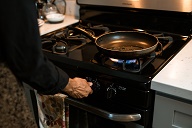 Image of someone cooking on a gas hob