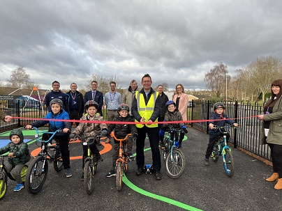 PHOTO of Executive Mayor Andy Abrahams with pupils from St Peter's Church of England Primary Academy in Mansfield as the Mayor prepares to cut the ribbon at the new Learn to Cycle Track on the town's Bellamy estate