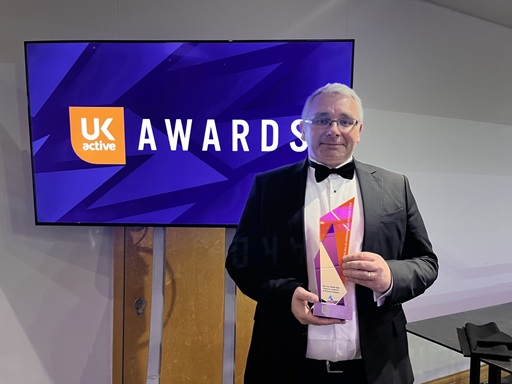 Cllr Andy Burgin holding the award at the ceremony