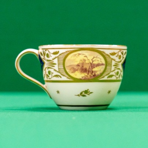 Teacup with dark blue and gilt, and panels with landscapes