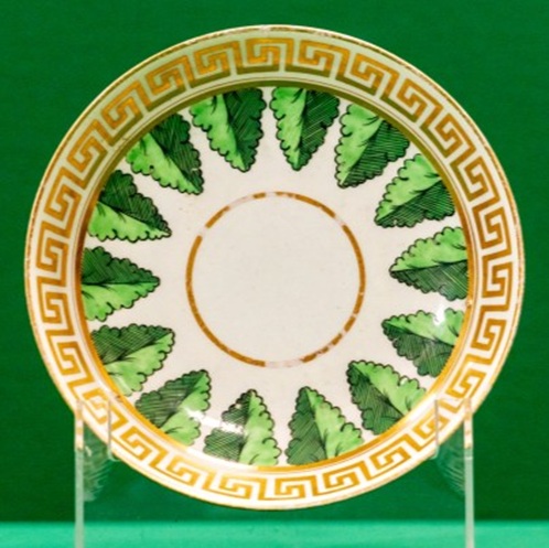 Saucer with gilt geometric border and green leaves