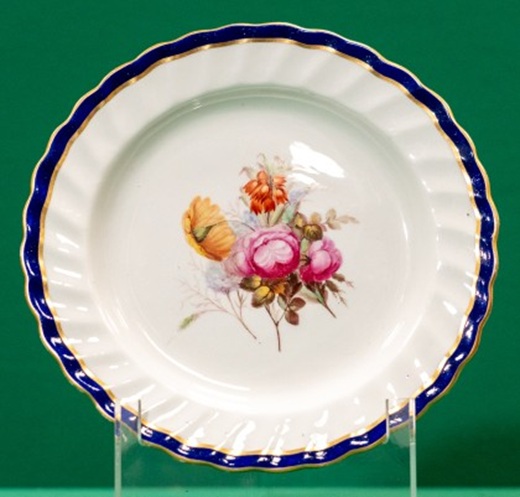 Plate with dark blue and gilt edge, decorated with a bunch of flowers