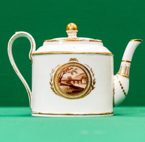 Teapot with a landscape in a roundel on the side