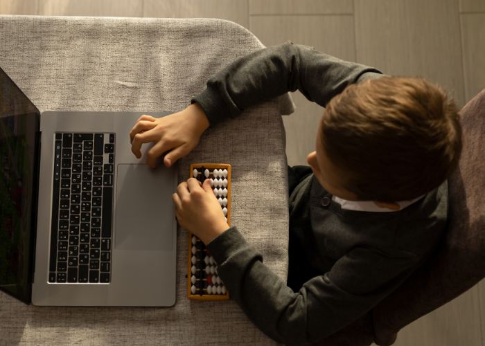 boy works on laptop