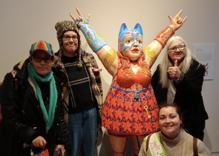 Group of women standing with sculpture