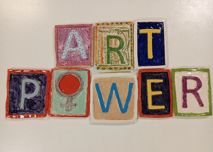 clay tiles spelling out art power