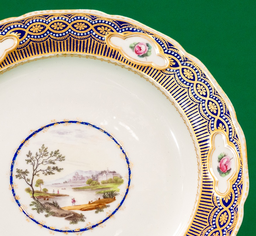 Detail of a plate with floral and landscape decoration