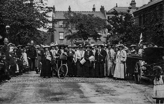 Suffragists gathered in a road