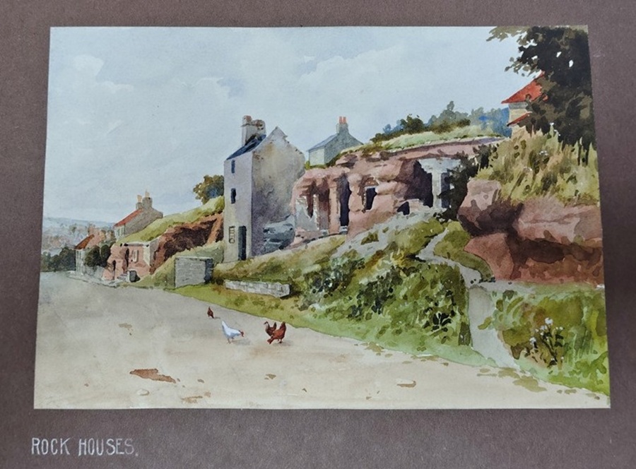 Mounted watercolour painting of homes cut into the rock