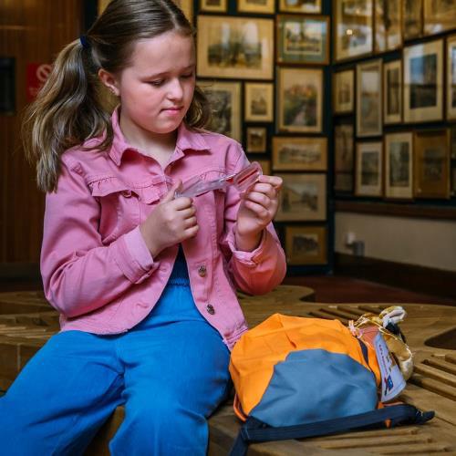 Museum visitor with an accessibility sensory bag.