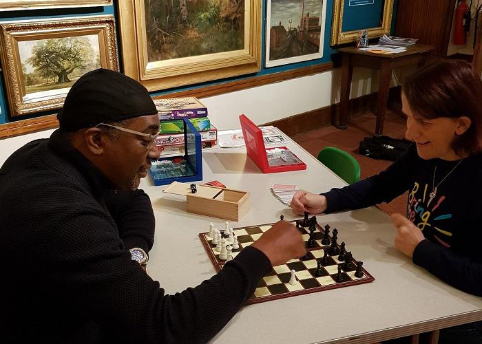 Photo of people playing a game at the games cafe