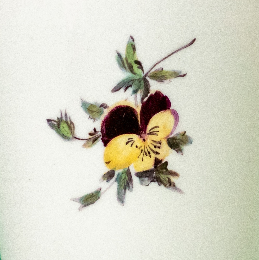Detail of a pansy painted on porcelain