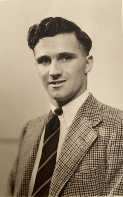 A sepia-toned head and shoulders portrait of a young man